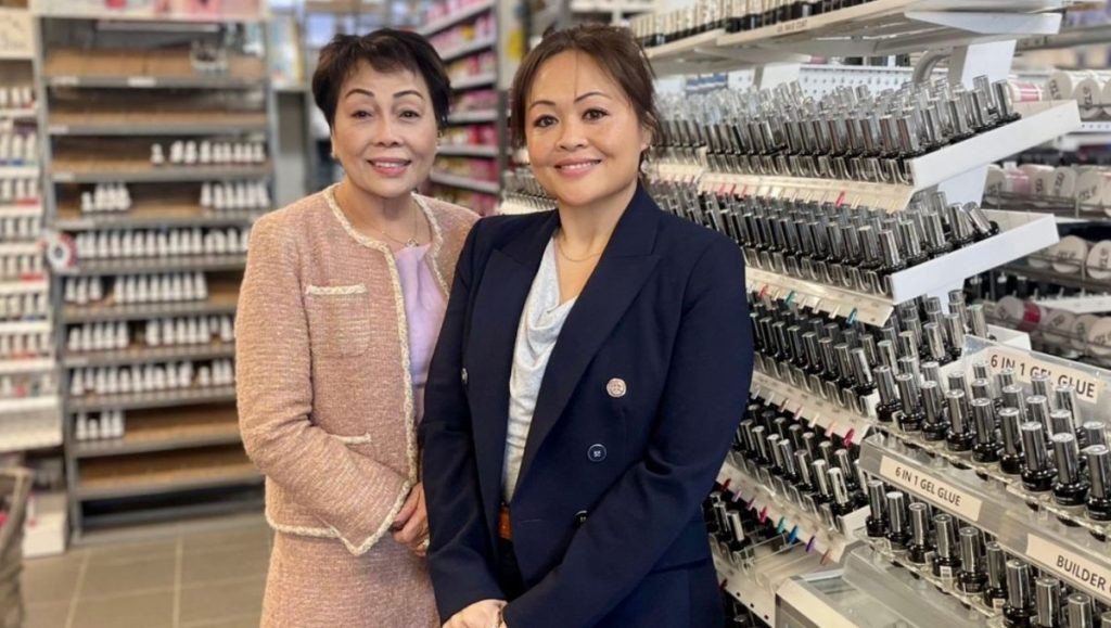 Vietnamese born businesswoman Lyn and Alexis in front of beauty products